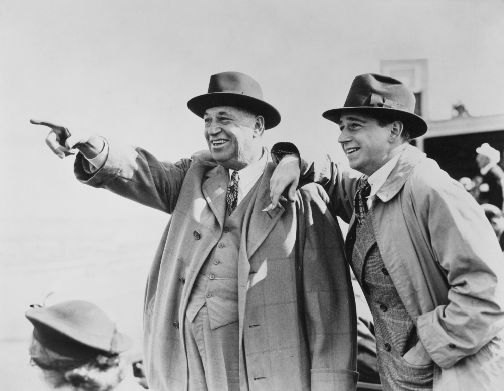 John D. Rockefeller, Sr. and his son John, Jr. leave a wedding in
