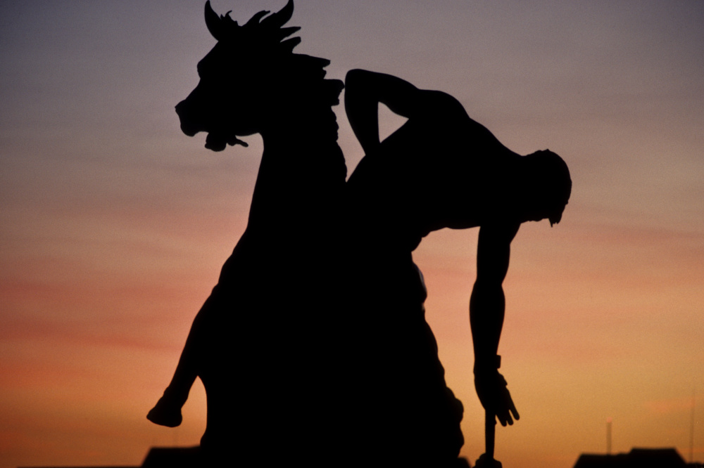 man on horseback sculpture at sunset