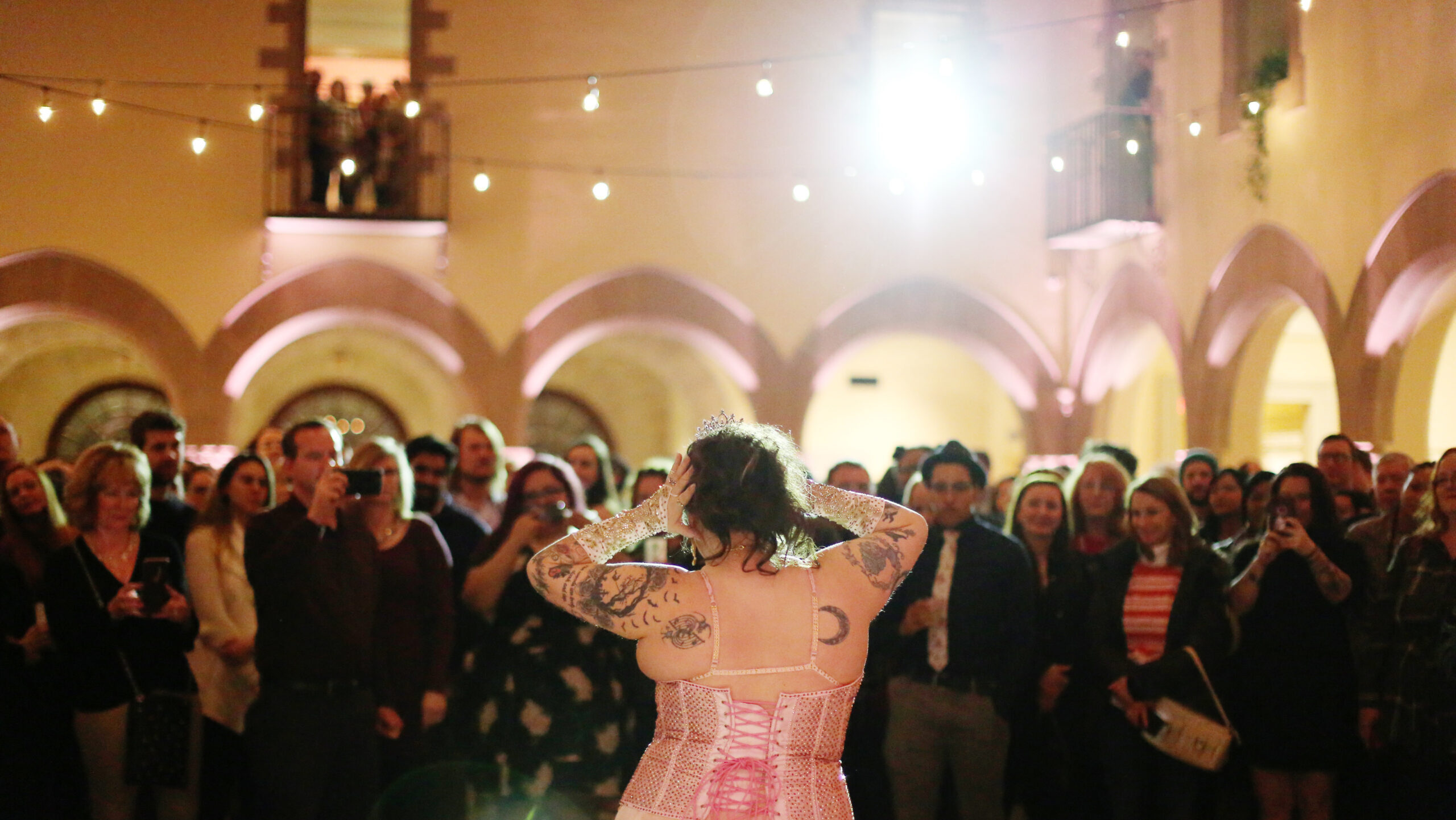 Tattooed woman in front of crowd