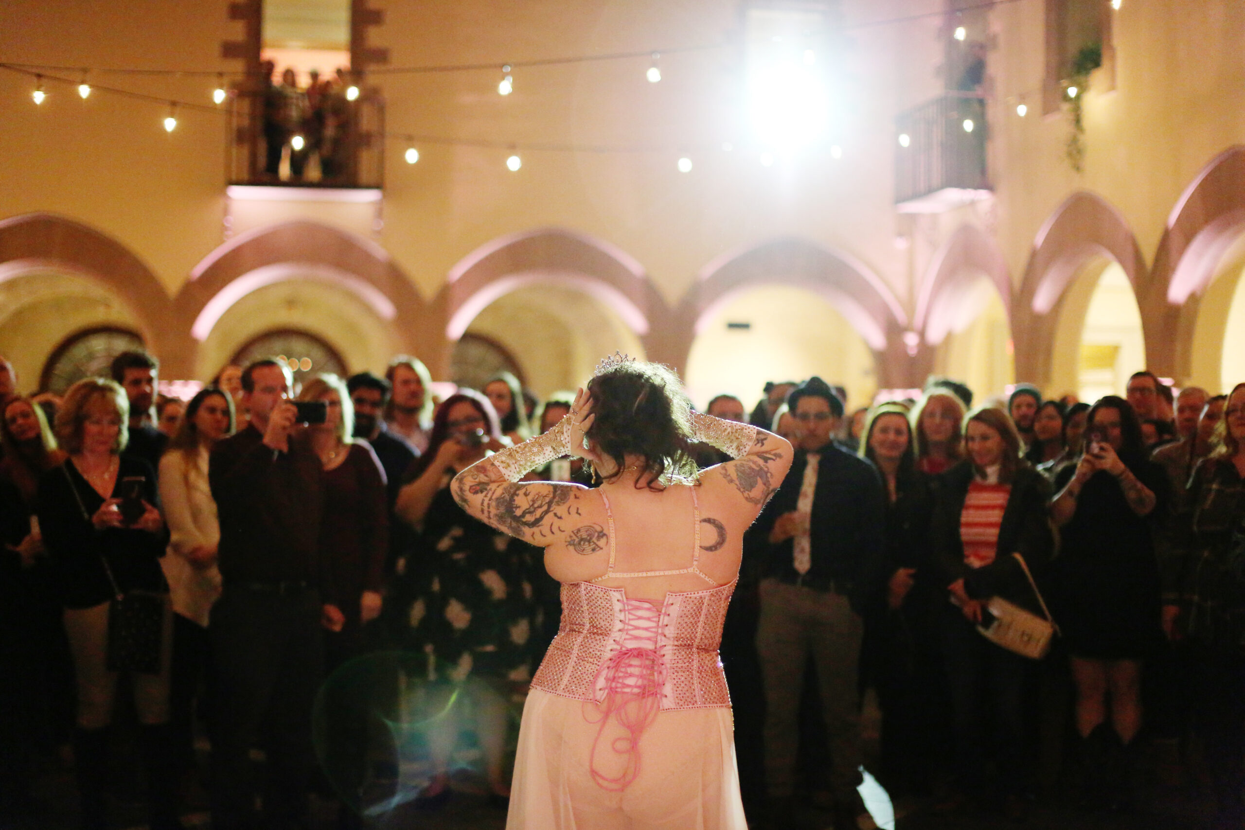 Tattooed woman in front of crowd