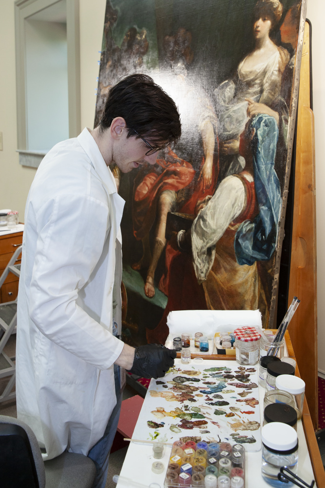 Conservator working on a painting