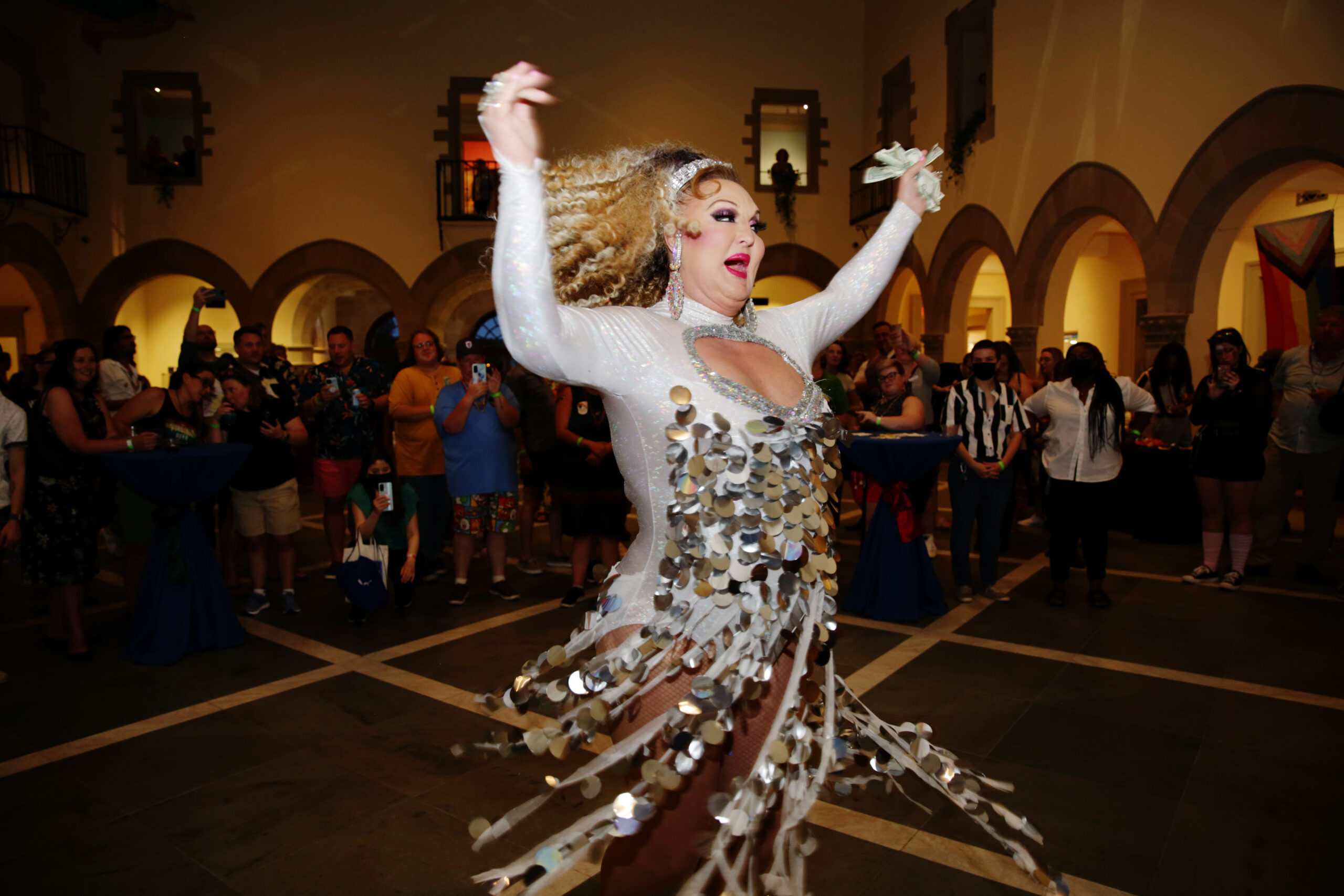 A drag queen twirls through the Chrysler's galleries in a sequins dress for the Chrysler Pride celebration, in collaboration with Hampton Roads Pride.