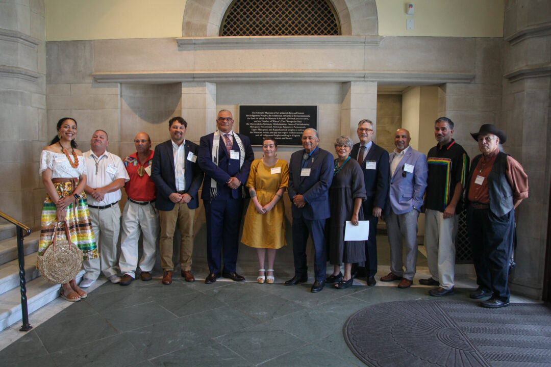 Members of the Chrysler Museum staff and members of the Native Advisory Committee stand in front of the newly unveiled plaque at the Museum's front entrance.
