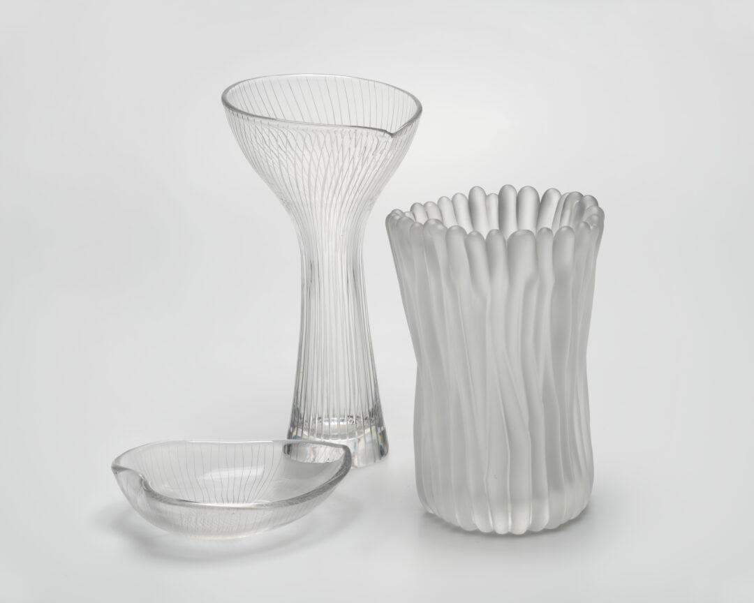 A group of glass objects, including an ashtray and two vases, designed by artist Tapio Wirkkala.