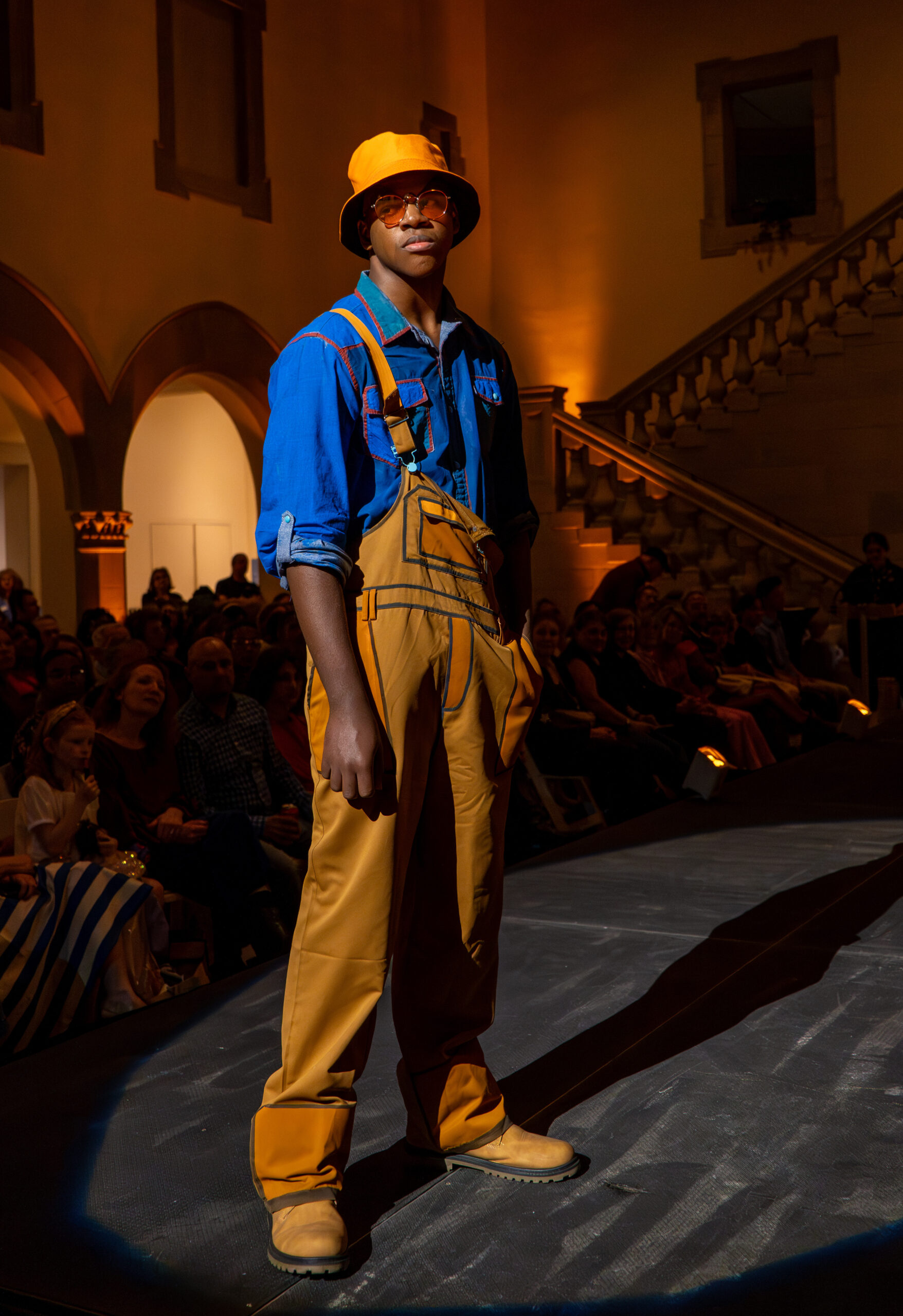 Student Model on runway - Hat, shirt, overalls