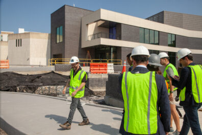 Perry Glass Studio Director, Robin Rogers, leads city officials on a hard hat tour of the Studio expansion.