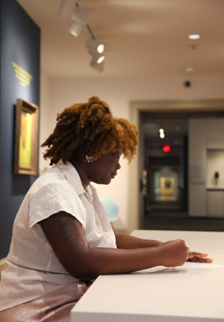 Summer Intern, Sanaa LaCore in the James Baldwin Exhibition she helped to organize.