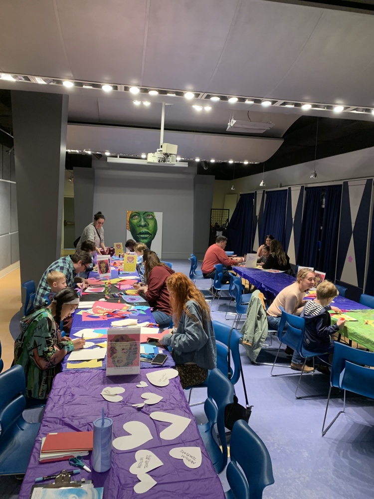 People participating in a second saturday art making activity