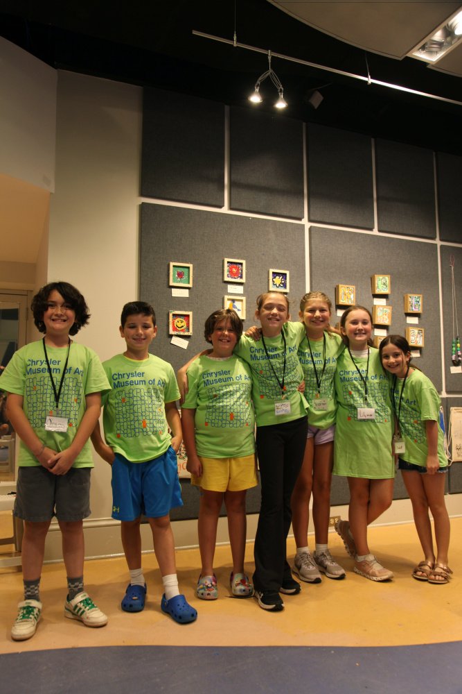 Summer Camp Children posing for group photo in front of their artwork