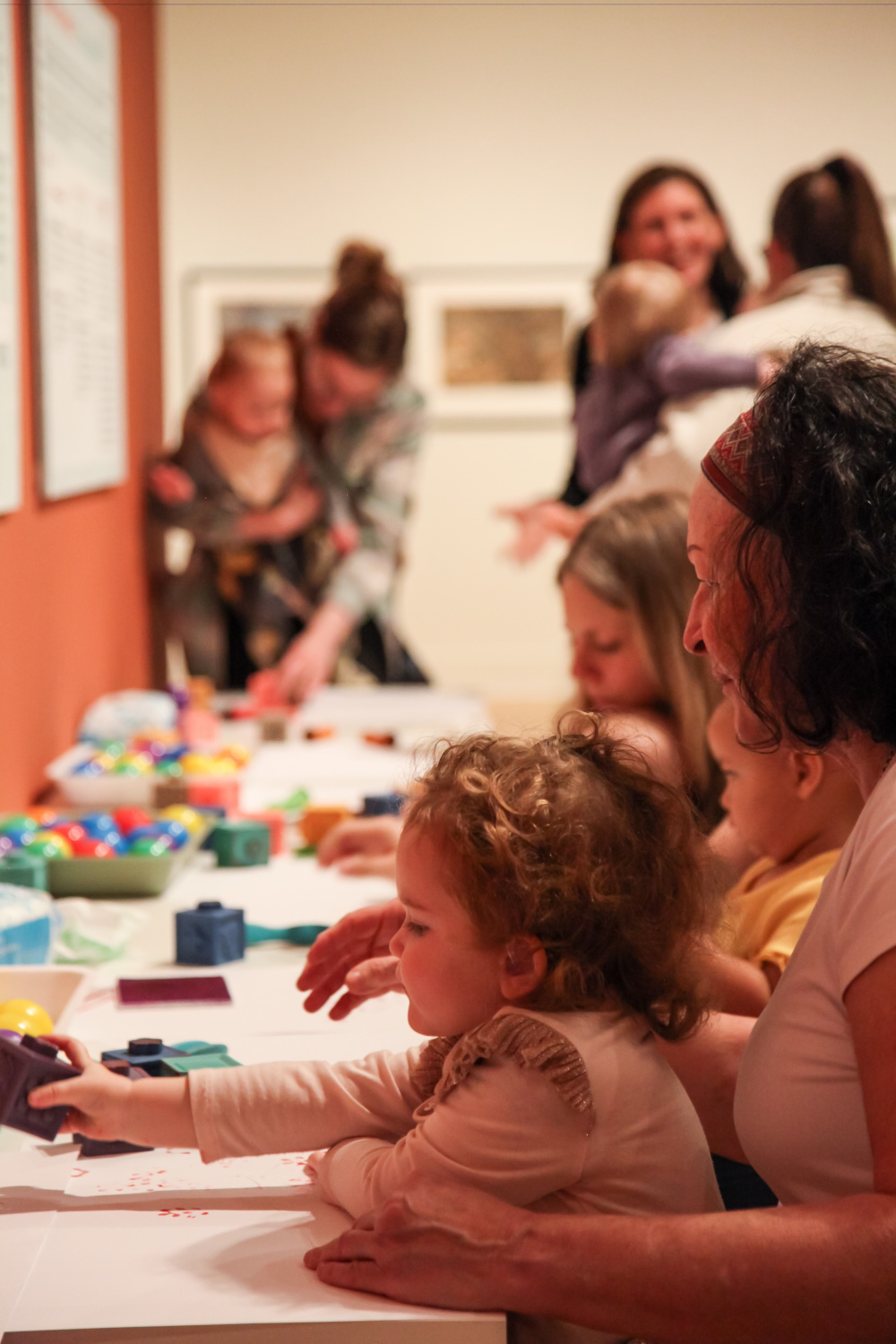Young children and guardians participating in art making activites.
