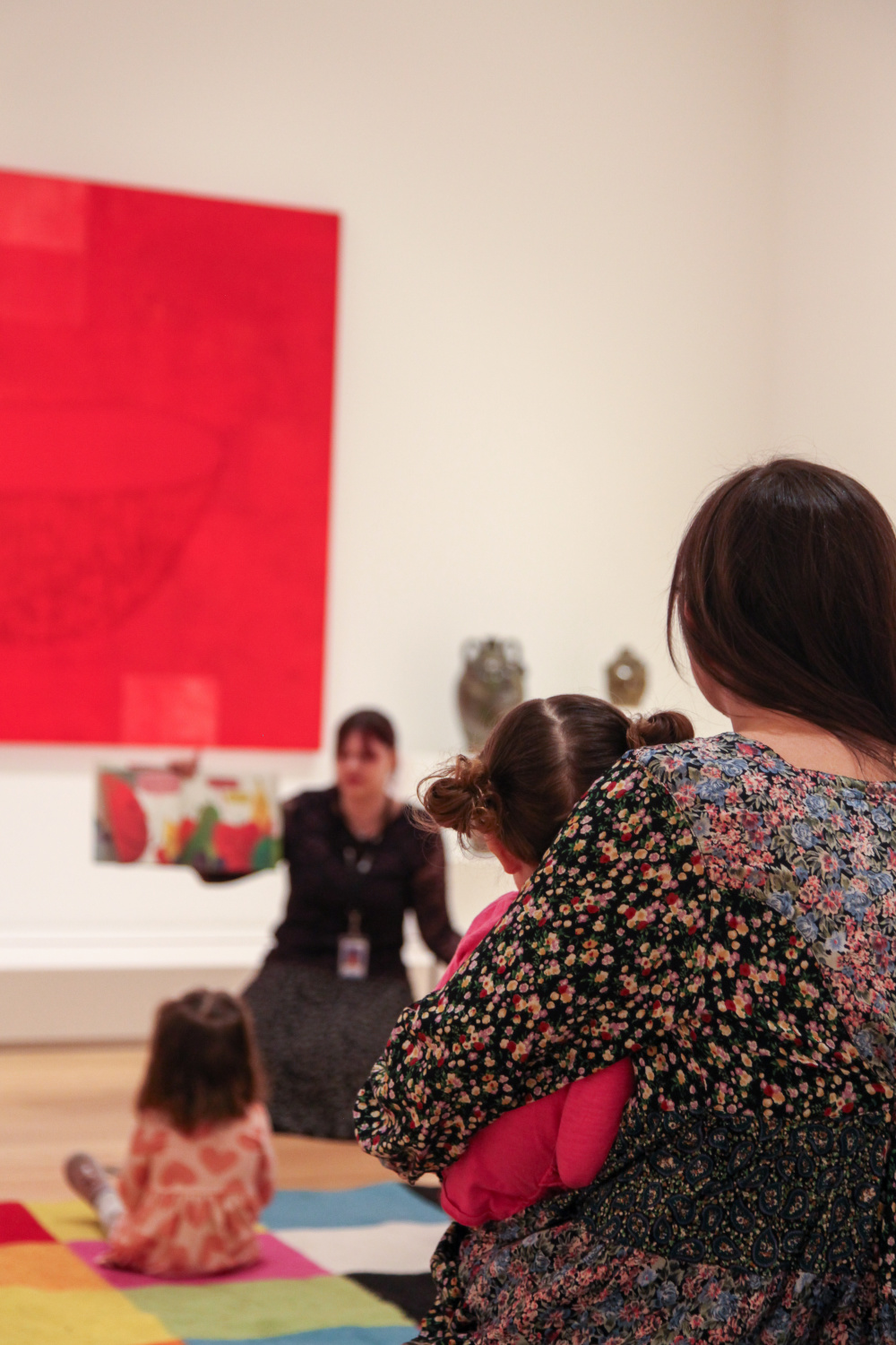 Children and families participating in story time in art gallery.