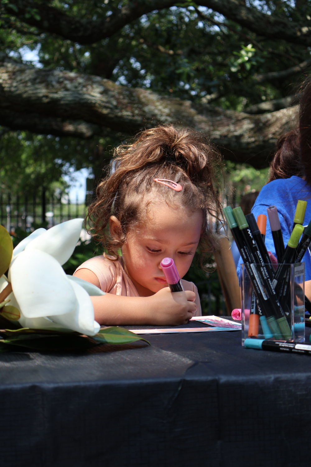 Child participating in art making activity in Mary's Garden