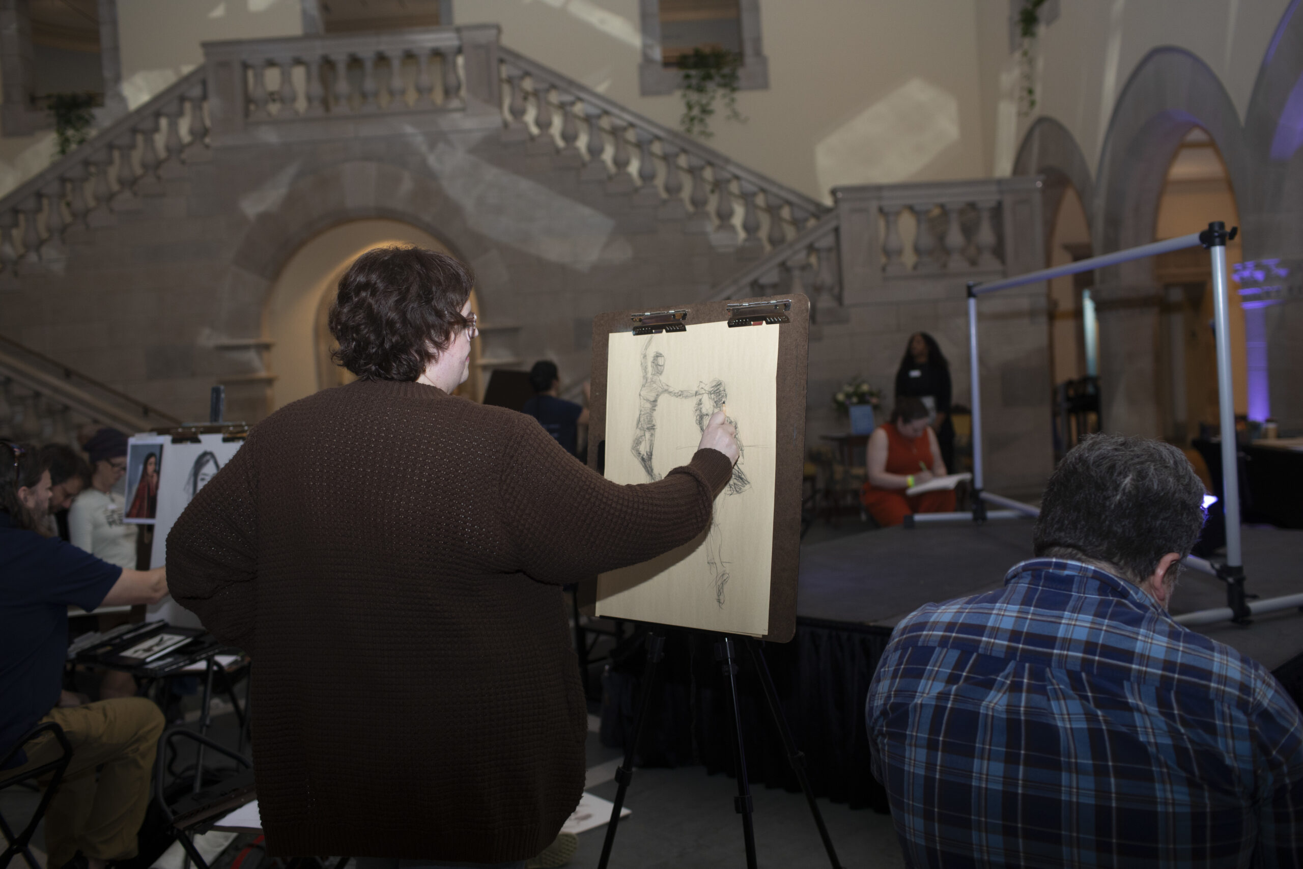 Artists sketching at Susan Watkins Exhibition Opening