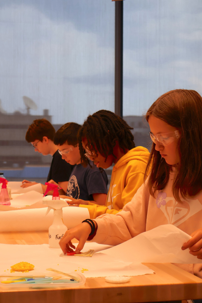 Teens working on project in glass studio classroom
