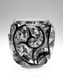 DescriptionVase/bowl of clear molded glass in high relief.