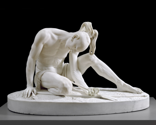 white marble sculpture of a wounded man