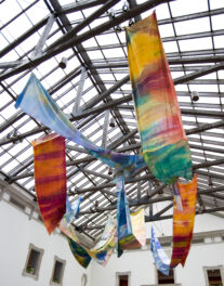 Colorfully painted banners drape from the skylights in Huber Court.