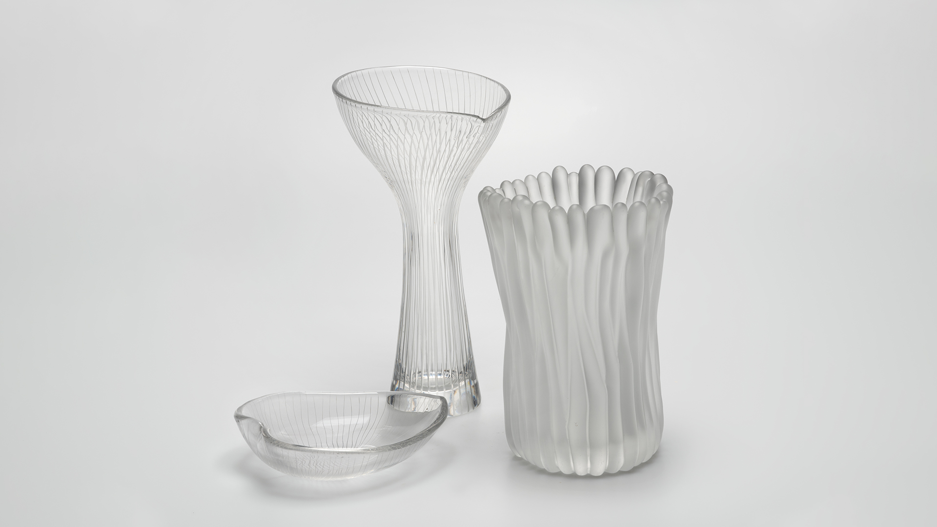 Group of glass objects. including ashtray and two vases, by artist Tapio Wirkkala.