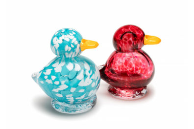 two glass ducklings on a white background