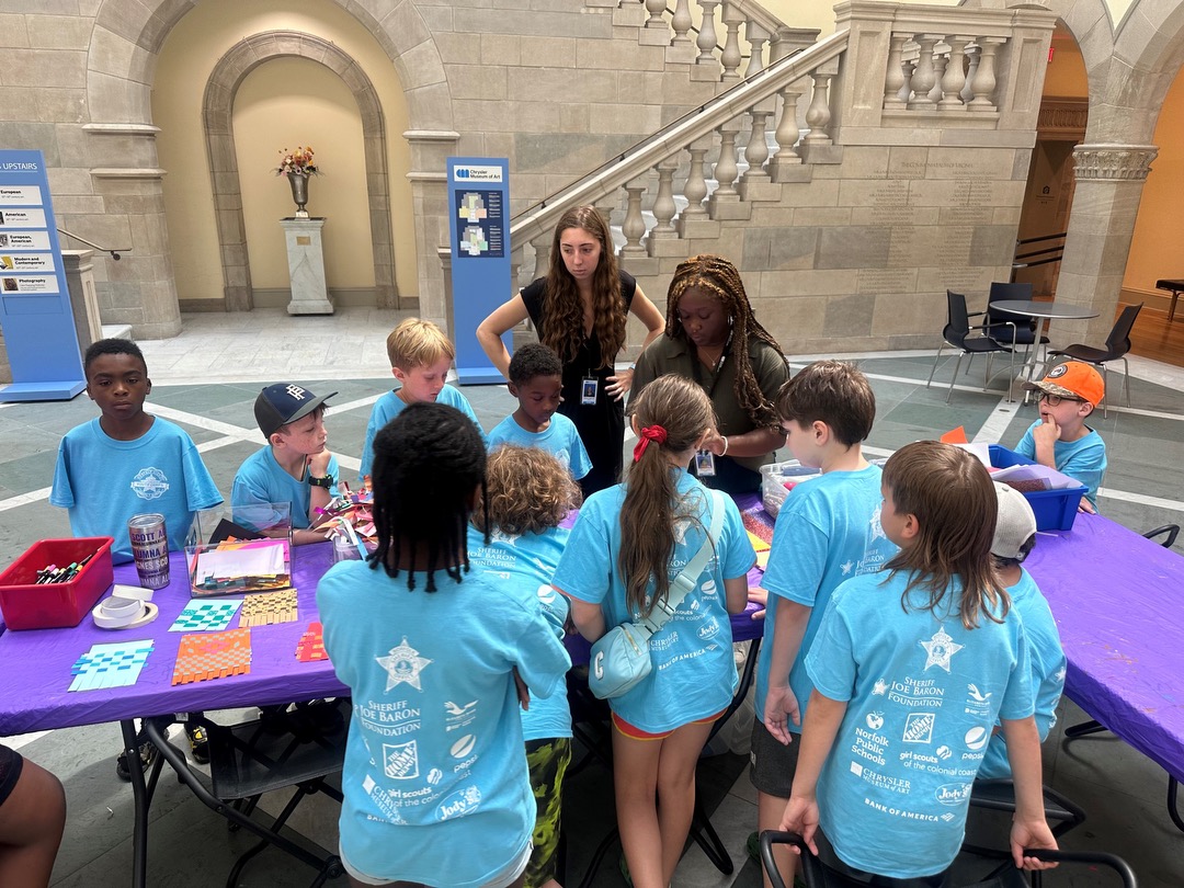 2024 Summer Interns, Sabine Krigsvold and Sanaa LaCore, lead an art activity for the Norfolk Sheriff's Youth Summer Camp.