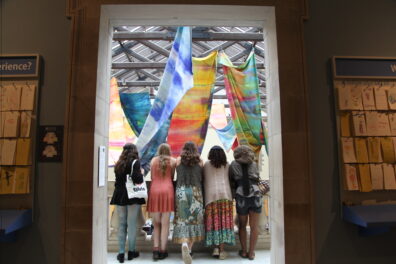 Teens looking out over Huber Court from top of staircase