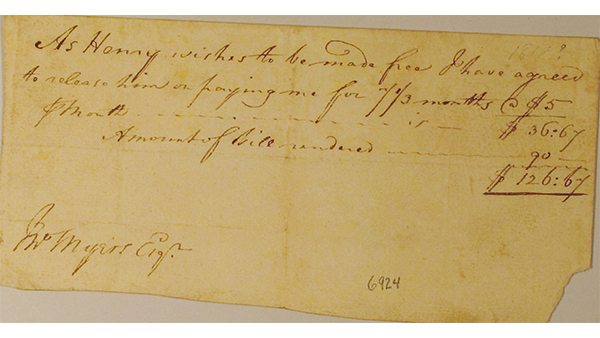 A photo of a yellowed, hand-written receipt for Henry who bought his freedom from the Myers family.