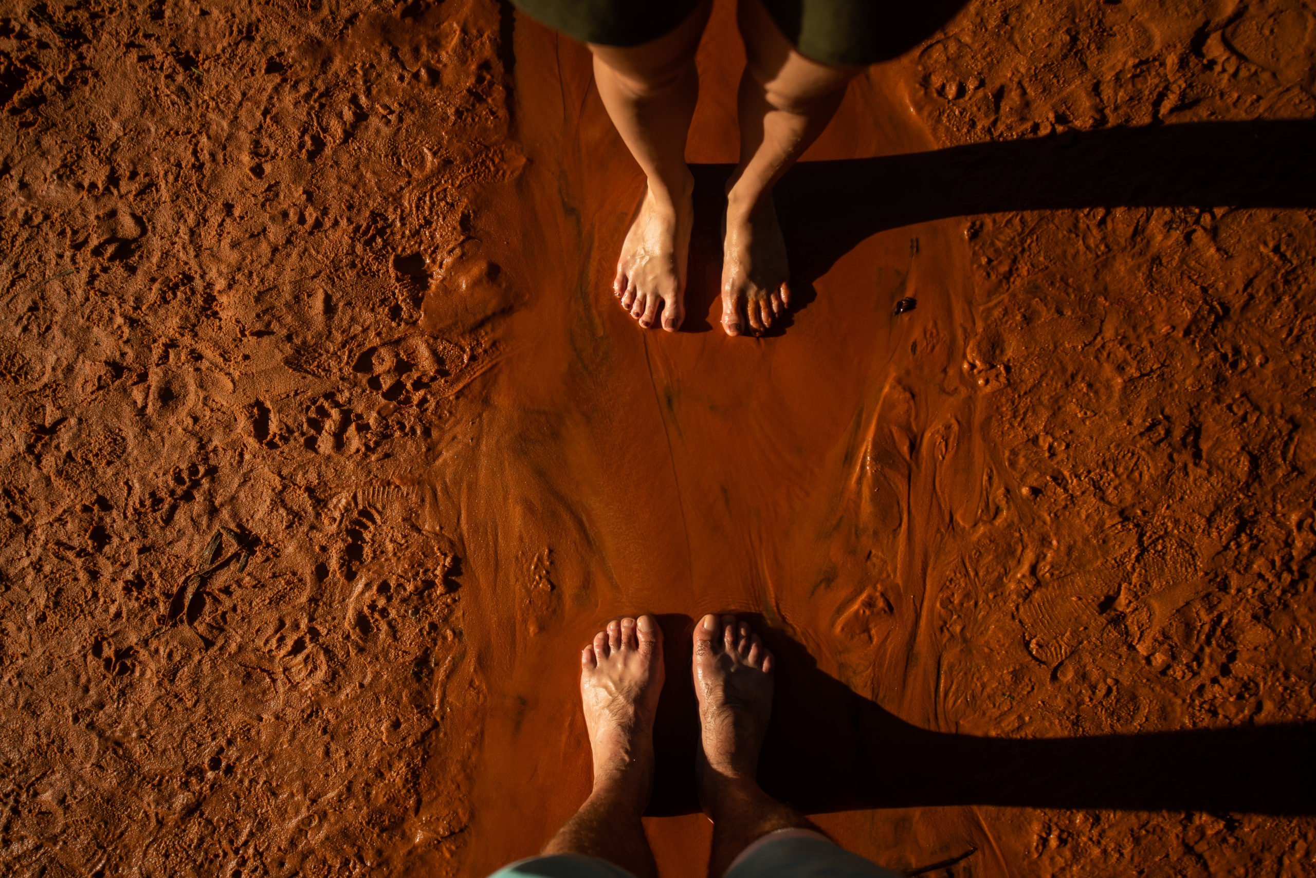 Feet on clay. Feet of a man and a woman on red clay, Vietnam
