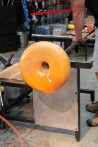 Glass art that looks like it's coming off a Krispy Kreme conveyor.