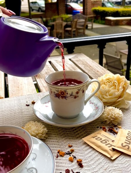 Pouring Tea in Zinnia Cafe's Outdoor Seating Area