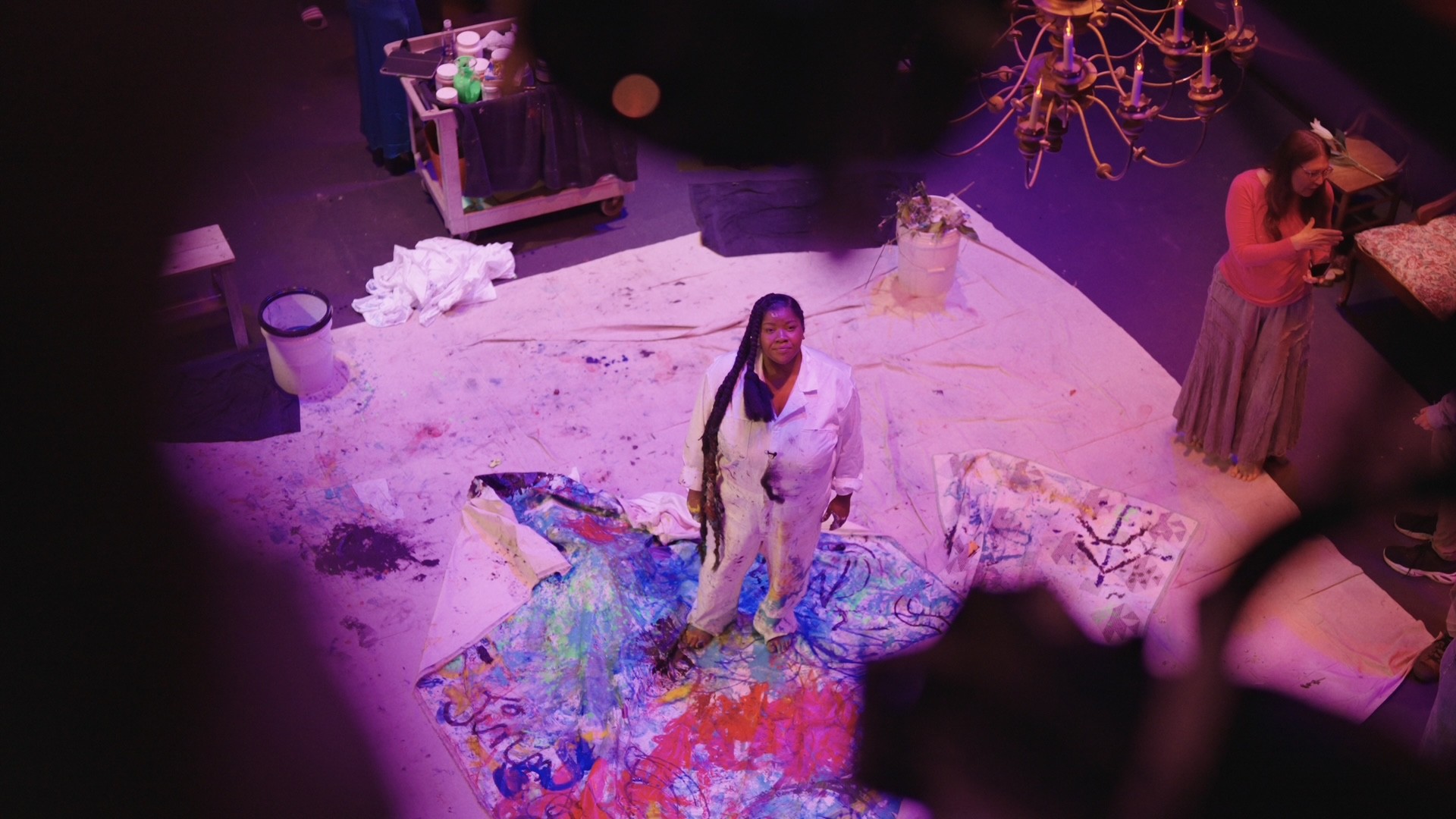 vanessa german standing with her art in progress.